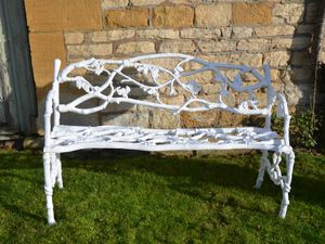 A 19th century cast iron garden seat of a twig and foliage design