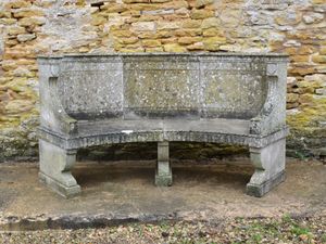 An Edwardian semi-circular Portland Stone garden seat