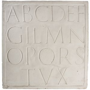 A plaster cast plaque of letters from the Trajan Column