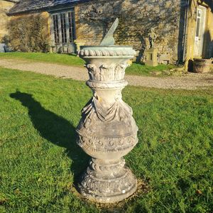 Carved Portland stone sundial with bronze dial plate