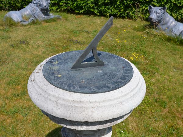 A Portland stone sundial pedestal with Negretti and Zambra dial Plate