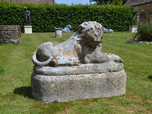 A pair of carved limestone recumbent lions 