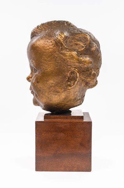 A gilt bronze baby portrait of Kirston Henderson 