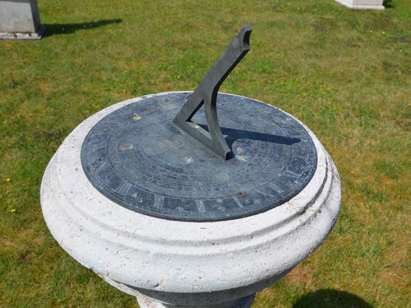 A Portland stone sundial pedestal with Negretti and Zambra dial Plate