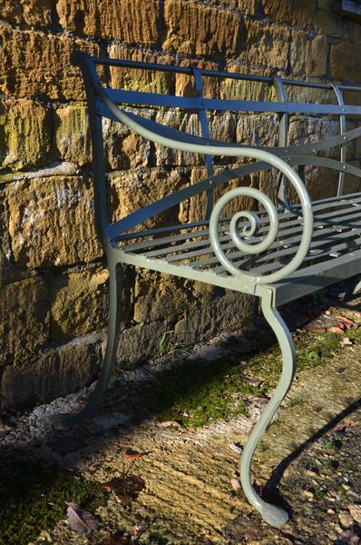 A 19th century wrought iron strap work garden seat 