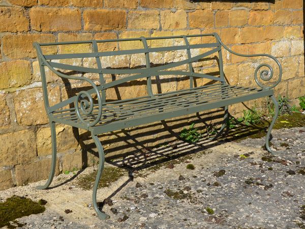 A 19th century wrought iron strap work garden seat 