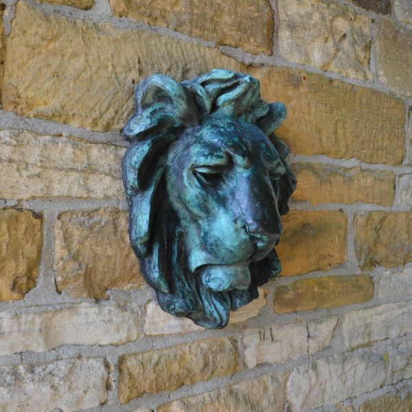 A modern bronze lion mask wall spout 