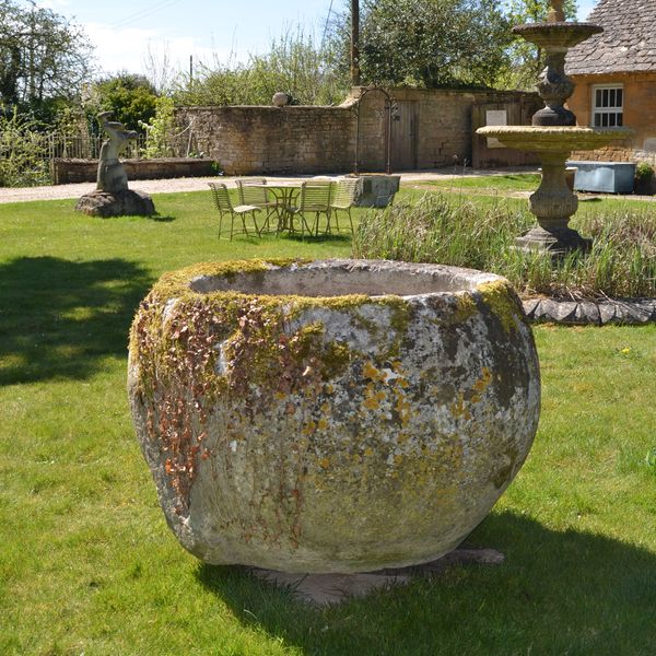An 18th century large circular stone trough