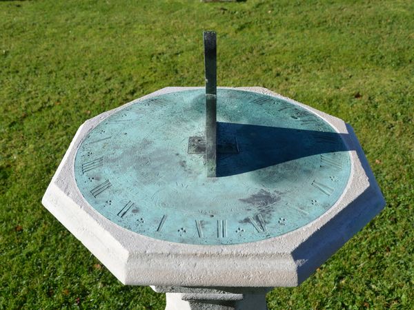 An 18th century Portland stone sundial pedestal with brass dial plate by Thomas Wright  (1711-1786)
