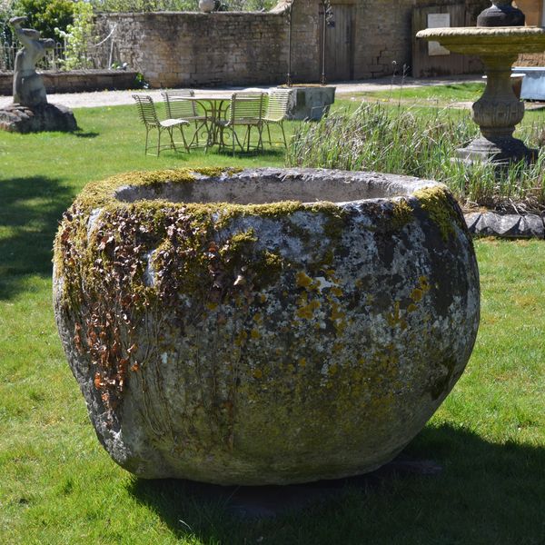 An 18th century large circular stone trough