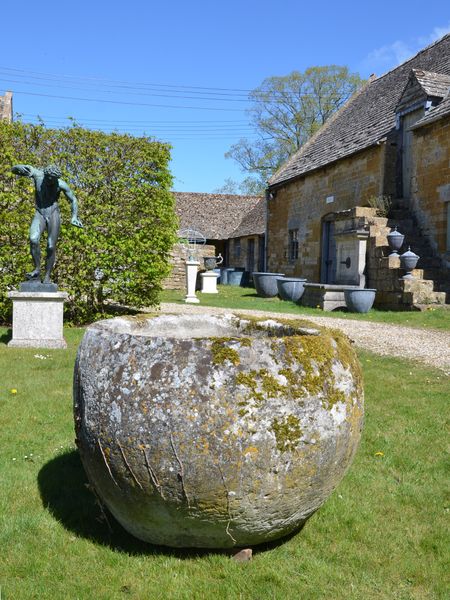 An 18th century large circular stone trough