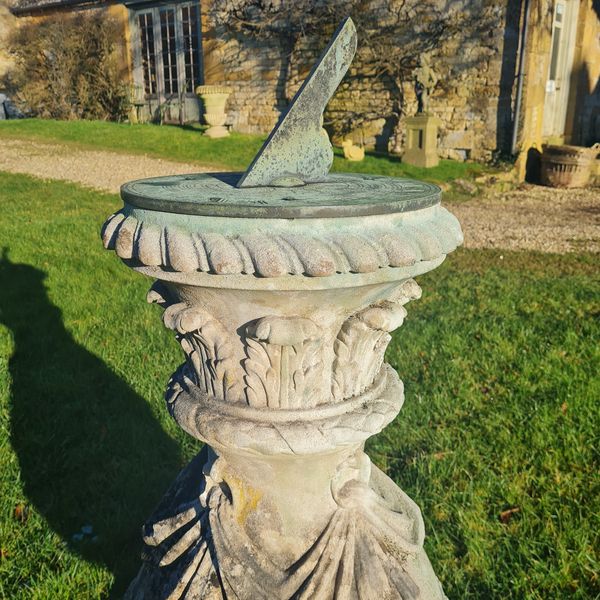 Carved Portland stone sundial with bronze dial plate