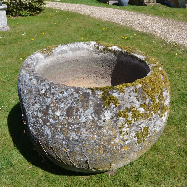 An 18th century large circular stone trough