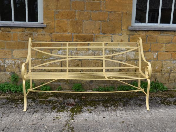 A 19th century wrought iron strapwork garden seat 