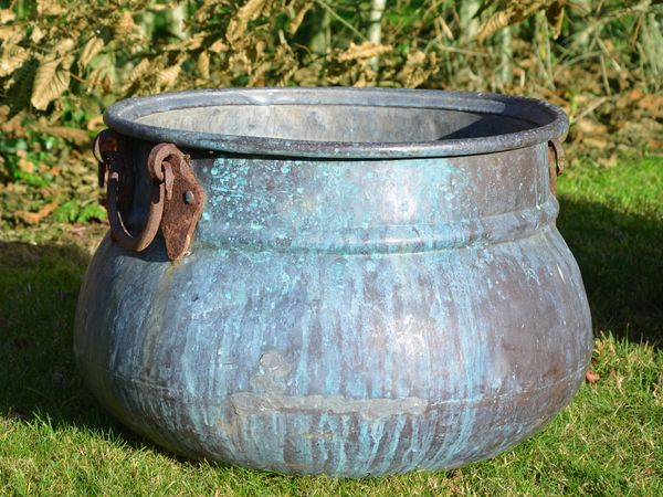A pair of vintage copper cauldron garden planters
