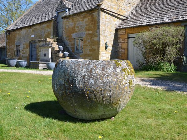 An 18th century large circular stone trough