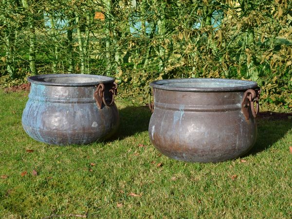 A pair of vintage copper cauldron garden planters