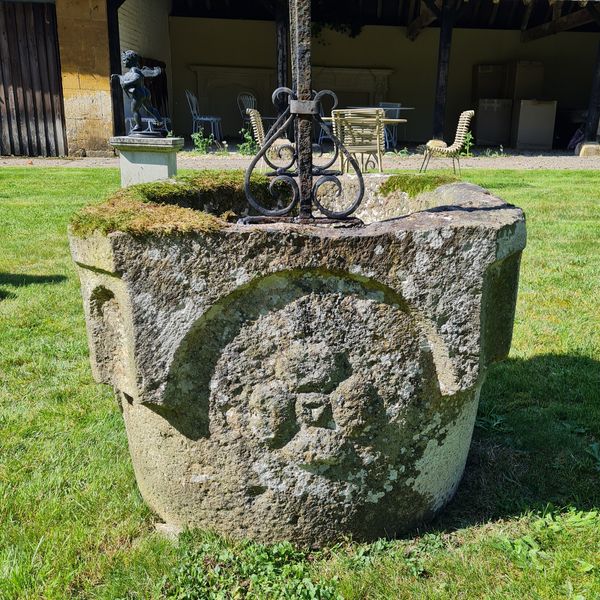 An Italian carved stone wellhead