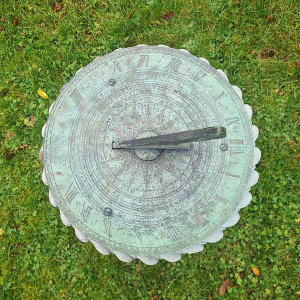 Carved Portland stone sundial with bronze dial plate