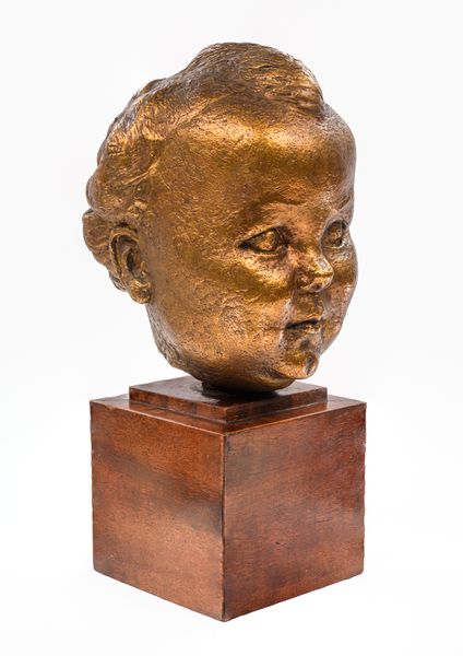 A gilt bronze baby portrait of Kirston Henderson 