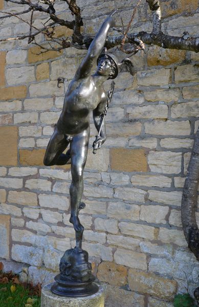 A bronze figure of Mercury after the model by Giambologna, raised on a marble column base