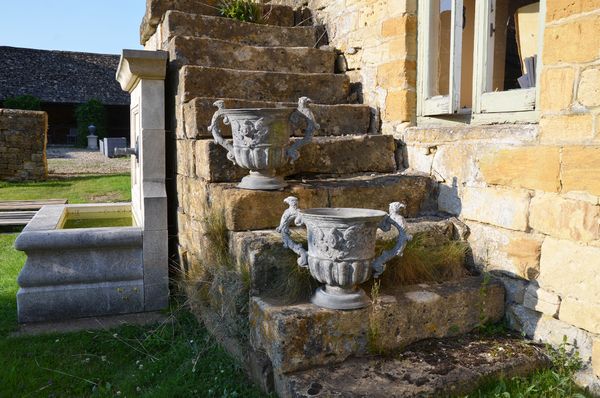 A pair of 18th century lead urns 