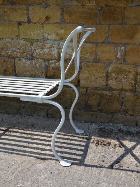 A vintage wrought iron garden bench