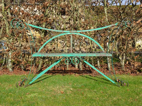A vintage painted iron strapwork garden seat 