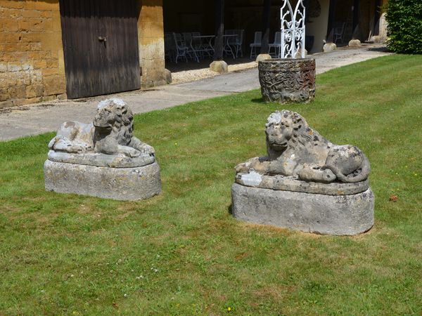 A pair of carved limestone recumbent lions 