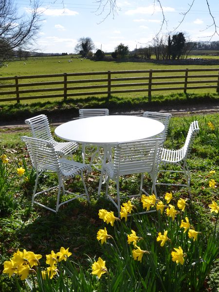The Large Circular Garden Dining Table with Six Ladderback Garden Chairs