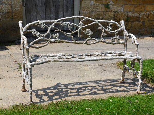 A 19th century cast iron garden seat of twig and foliage design