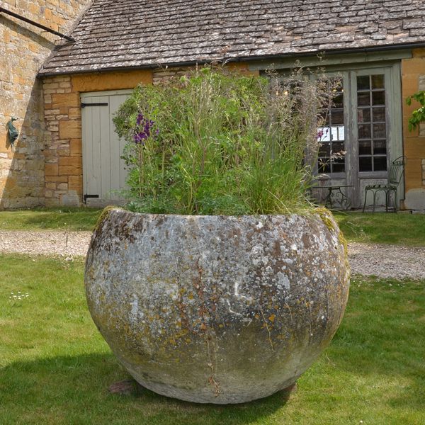 An 18th century large circular stone trough