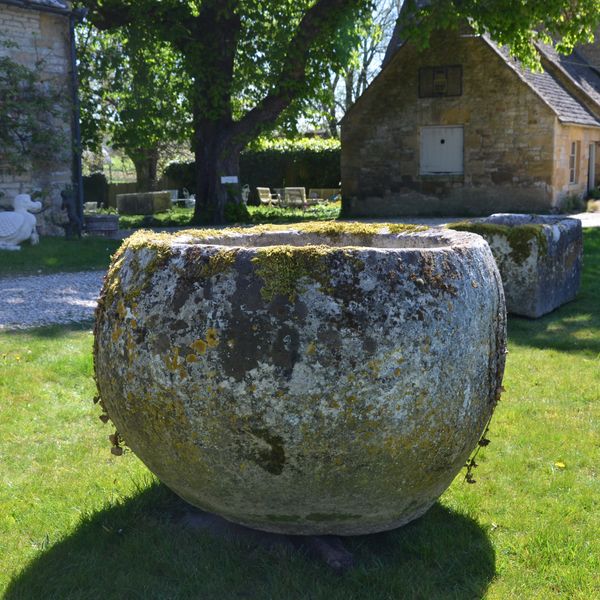 An 18th century large circular stone trough
