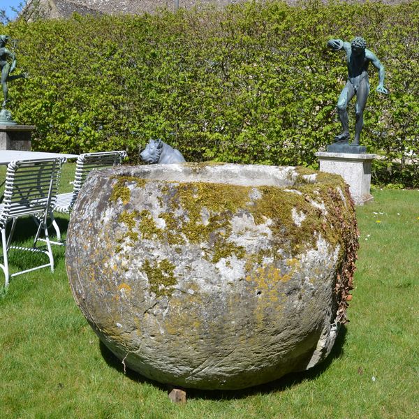An 18th century large circular stone trough
