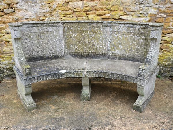 An Edwardian semi-circular Portland Stone garden seat