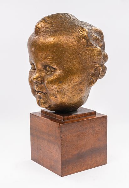 A gilt bronze baby portrait of Kirston Henderson 