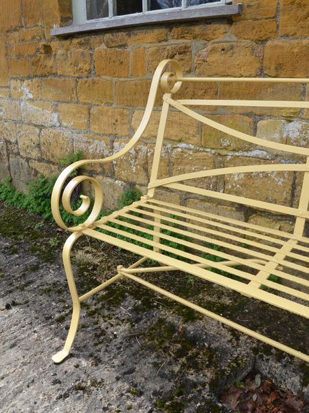 A 19th century wrought iron strapwork garden seat 