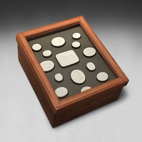A framed & boxed collection of 61 intaglios / plaster medallions