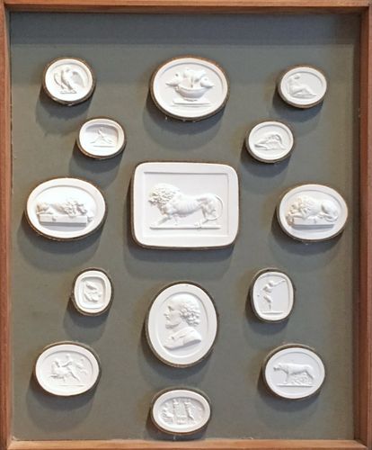 A framed & boxed collection of 61 intaglios / plaster medallions