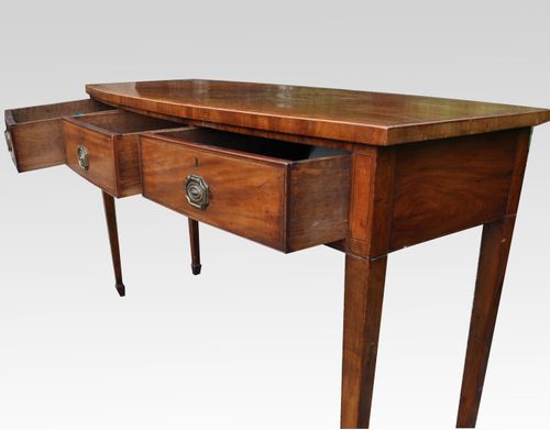A George III mahogany bow fronted three drawer side/serving table/sideboard
