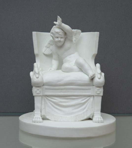 Sevres Biscuit figure of Cupid on a Chair